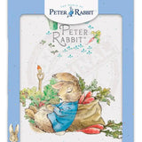 Peter Rabbit asleep next to radish sack metal sign