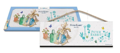 Beatrix Potter Peter Rabbit sitting next to watering can wooden sign